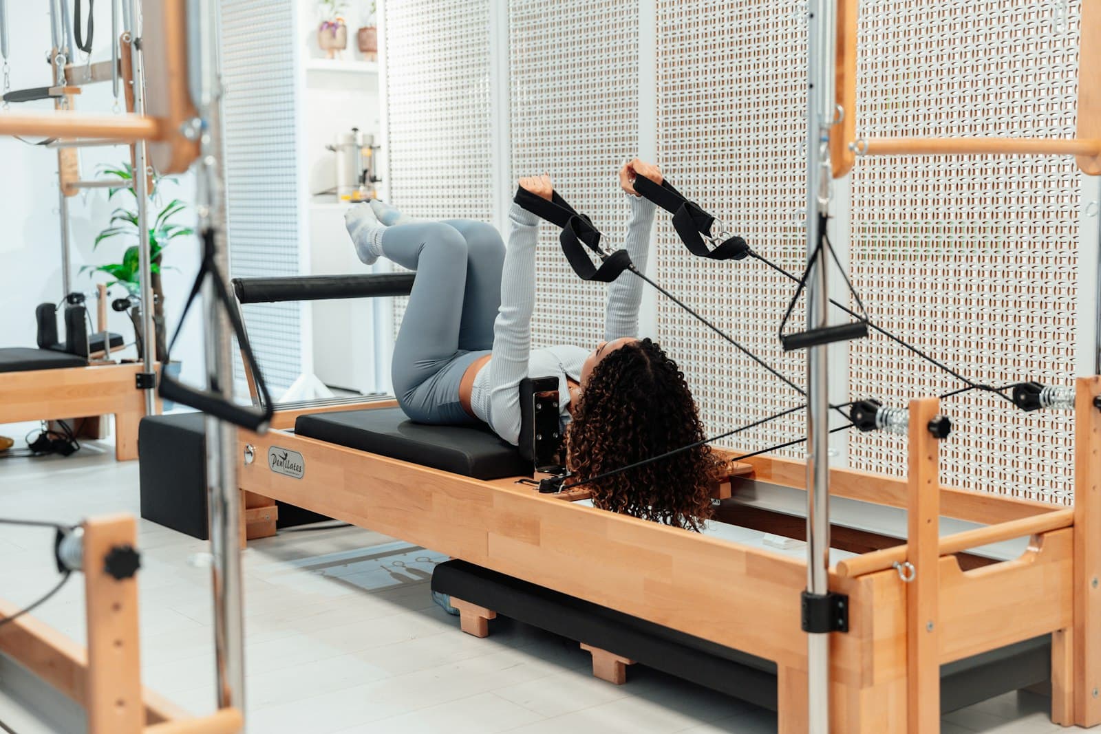 A woman is doing exercises on a rowing machine