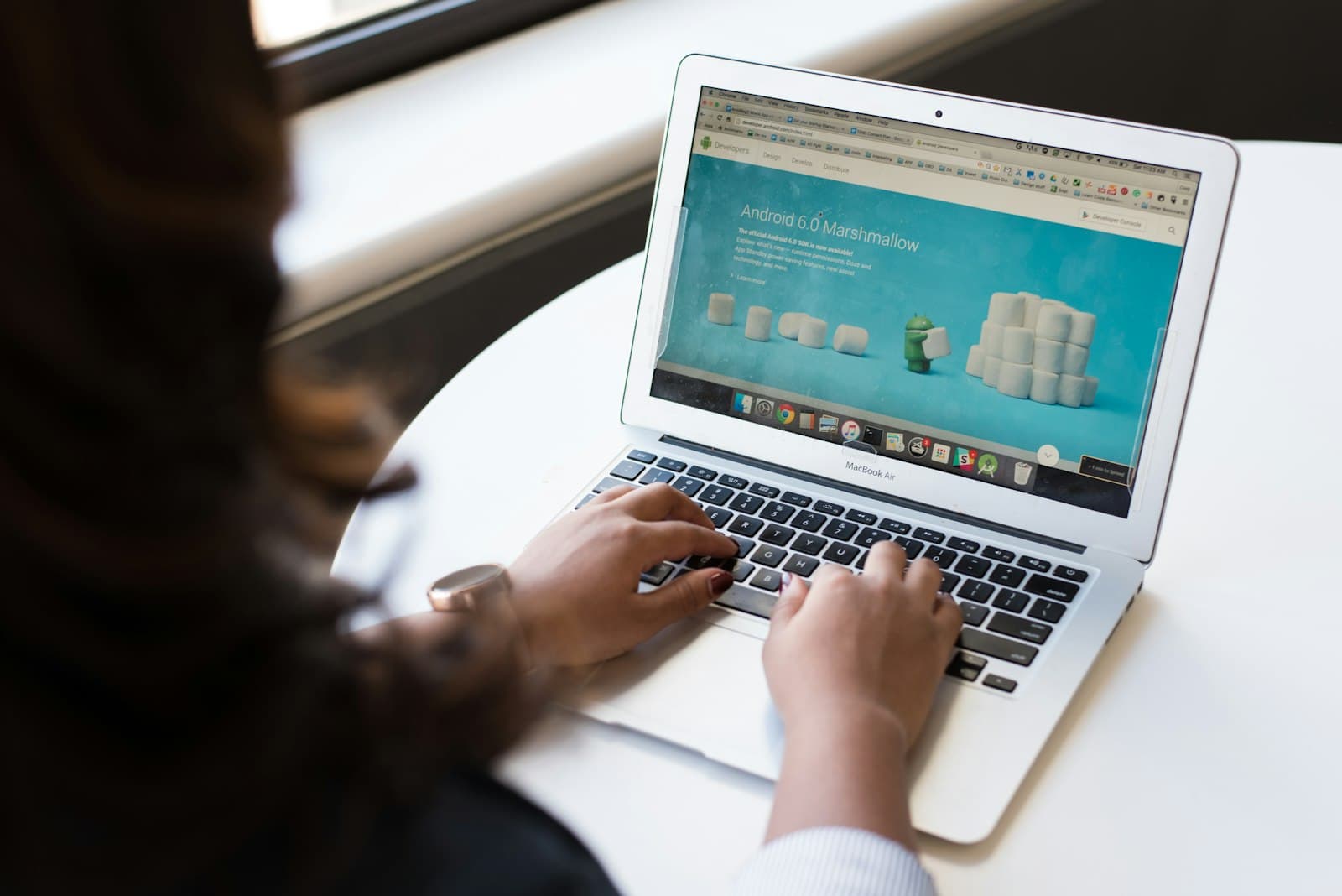 Woman using MacBook Air on table